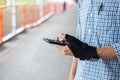 Young man holding his wrist pain because using smartphone long time. De Quervain`s tenosynovitis, Intersection Symptom, Carpal Royalty Free Stock Photo