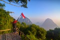 A young man holding Indonesian flag in the mountain peak. Indonesian independence day