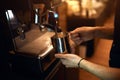 Young man holding a iron turk usinig coffeemachine