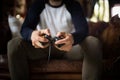 A young man holding joystick, playing video game.