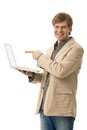 Young man holding laptop with blank screen