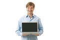 Young man holding laptop with blank screen