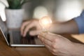 Young man holding lighting bulb in hands, having creative idea. Royalty Free Stock Photo