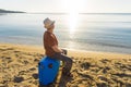 Young man holding luggage at the sea. Travel, summertime, holidays and people concept. Royalty Free Stock Photo