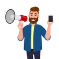 Young man holding a megaphone or loudspeaker and showing a mobile, cell, smart phone in hand. Announcement, sales, offer, product.