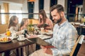 Young man holding a menu and choosing what to order Royalty Free Stock Photo