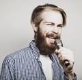 Young man holding a microphone and singing Royalty Free Stock Photo