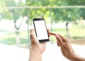 Young man holding mobile phone with blank screen Royalty Free Stock Photo