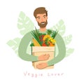 Young Man holding natural fruits and vegetables in grocery paper bag. Vegan man with organic products Royalty Free Stock Photo