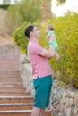 Young man holding a newborn baby in his arms on the summer background. Newborn photosession. Family portrait. Father and his son. Royalty Free Stock Photo