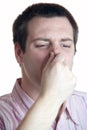 Young man holding nose Royalty Free Stock Photo