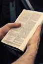Young man holding an open bible, reading and taking notes Royalty Free Stock Photo