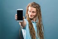 Young man holding out a cellphone Royalty Free Stock Photo