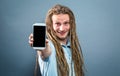 Young man holding out a cellphone Royalty Free Stock Photo