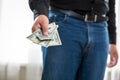 Young man holding pack of dollars and condom Royalty Free Stock Photo