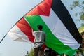 a young man holding a Palestinian flag