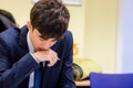 A Young Man Holding a Pen Concentrating