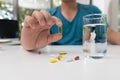 Young man holding pharmaceutical medicine pills in hand Royalty Free Stock Photo