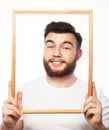 Young man holding picture frame Royalty Free Stock Photo