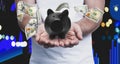 Young man holding piggy bank and American dollars falling on background, closeup Royalty Free Stock Photo