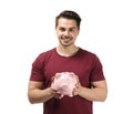 Young man holding piggy bank on white background. Money savings concept Royalty Free Stock Photo