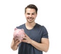 Young man holding piggy bank on white background. Money savings concept Royalty Free Stock Photo