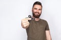 Young man holding and playing with fidget spinner.