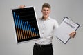 Young man holding a poster with statistics and contract isolated on a light background