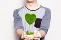 Young man holding a pot of tree in heart-shape in white Royalty Free Stock Photo