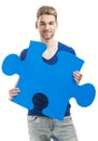 Young man holding a puzzle piece Royalty Free Stock Photo