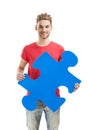 Young man holding a puzzle piece Royalty Free Stock Photo