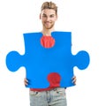 Young man holding a puzzle piece Royalty Free Stock Photo