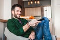 Young man holding remote controller watching tv Royalty Free Stock Photo