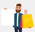 Young man holding shopping bags. Person showing a blank white poster, board, banner in hand. Male character illustration. Royalty Free Stock Photo