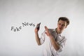 Young man holding smartphone in his hands. Antipathy, dislike and refuse concept. Fake news Royalty Free Stock Photo