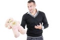 Young man holding stuffed teddy bear as a gift