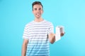 Young man holding toilet paper roll Royalty Free Stock Photo