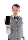 Young man holding up his cell phone in a vest Royalty Free Stock Photo