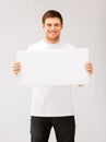 Young man holding white blank board Royalty Free Stock Photo