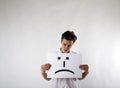 Young man holding white paper in his hands. Displeased and Unhappy man Royalty Free Stock Photo