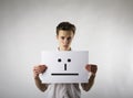 Young man is holding white paper with smile. Serious man Royalty Free Stock Photo