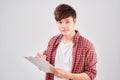 Young man holding wood clipboard and pen in hand and happy smile portrait on white isolated background Royalty Free Stock Photo