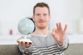 Young man holding world globe