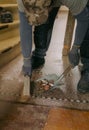 A young man holds a bag of construction waste indoors. Royalty Free Stock Photo