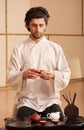 A young man holds a Chinese tea ceremony Royalty Free Stock Photo