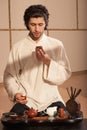 Young man holds a Chinese tea ceremony