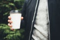 Young man holds a cup of coffee in his hands Royalty Free Stock Photo