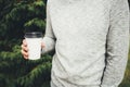 Young man holds a cup of coffee in his hands Royalty Free Stock Photo