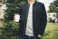 Young man holds a cup of coffee in his hands Royalty Free Stock Photo
