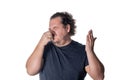 A young man holds or pinches his nose shut because of a stinky smell or odor. Isolated on a white background
